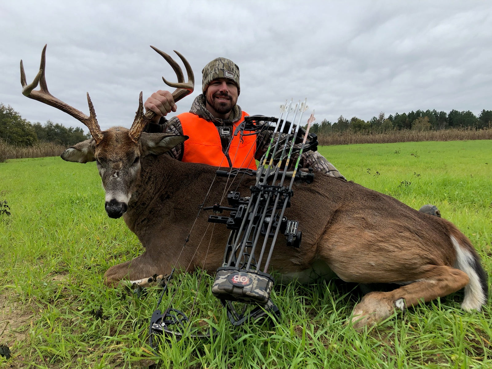 Man with Trophy Whitetail Buck using Top 2024 Scrape juice Deer Lure