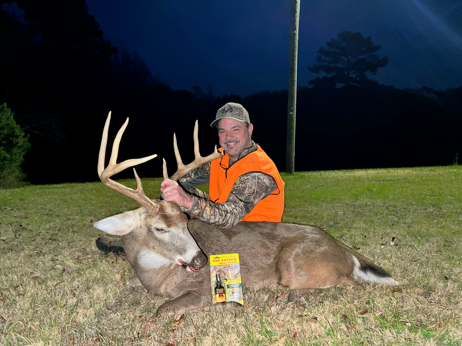 Man with Trophy Whitetail Buck using Top 2024 Scrape Juice Doe Estrus Heat Plus Deer Lure