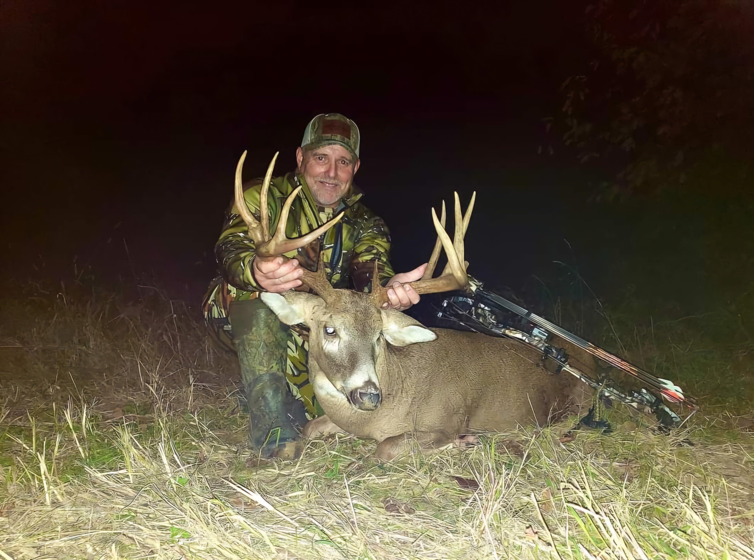 Jeff Hazenfield holding huge trophy whitetail by antlers best deer lure and deer attractant 2024