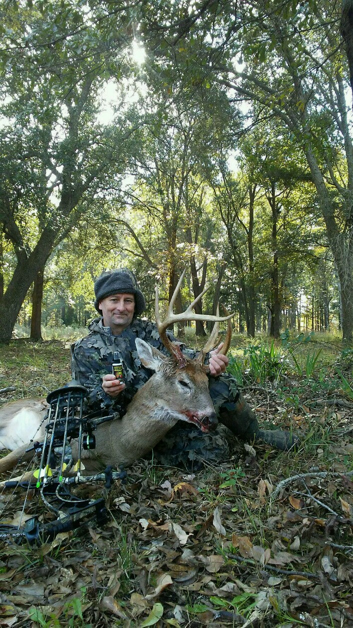 Hunting triumph with Scrape Juice, an all-natural deer attractant using tarsal glands - A hunter celebrating his catch, highlighting Scrape Juice as the essential tool for successful hunting. This all-natural deer lure, made with tarsal glands, proves to be the best choice for attracting deer and ensuring hunting success.